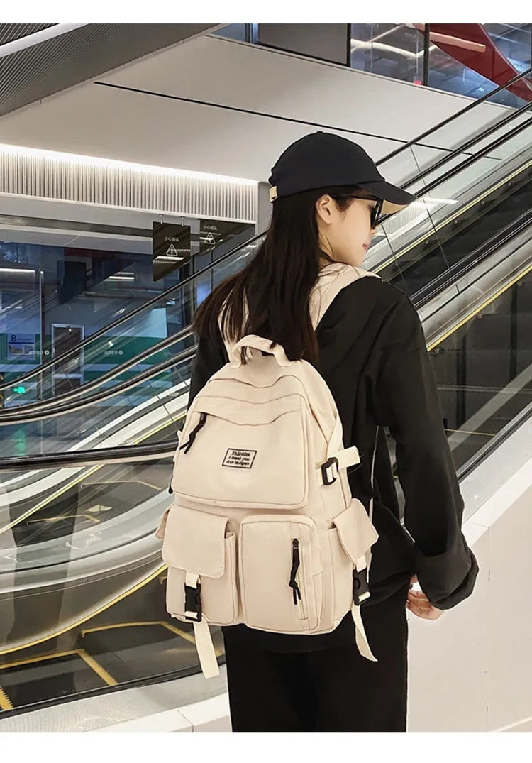 Soft nylon student backpack in black or white with computer compartment and three-dimensional pockets
