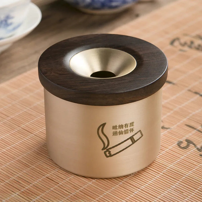Retro-style brass ashtray with a wooden lid, shown in a home living room setting.