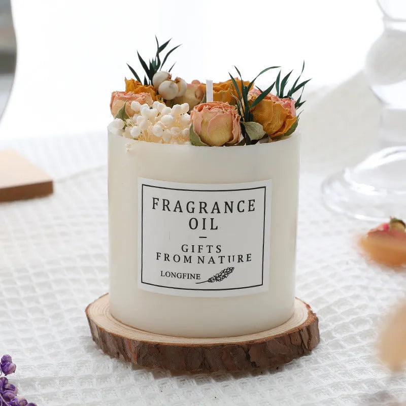 Decorative aromatherapy candle with dried flowers embedded in solid wax, shown with optional wooden chip base.