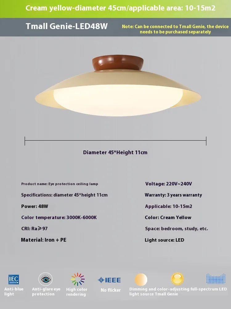 Modern flying saucer shaped ceiling lamp with an iron shade, shown in a cream yellow finish.