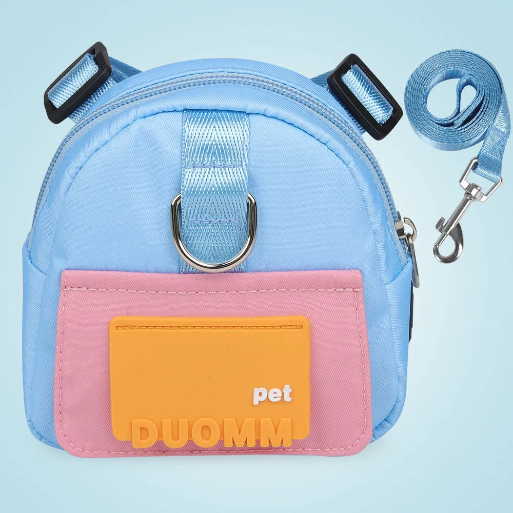 Blue adjustable dog harness backpack with storage compartment and tow rope shown on a medium-sized dog.