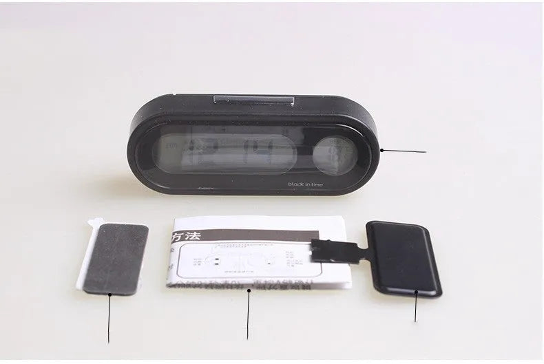 Black electronic car clock and thermometer unit with LED display on adjustable bracket.