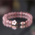 Women's casual crystal bracelet with a strawberry quartz peach blossom flower charm.