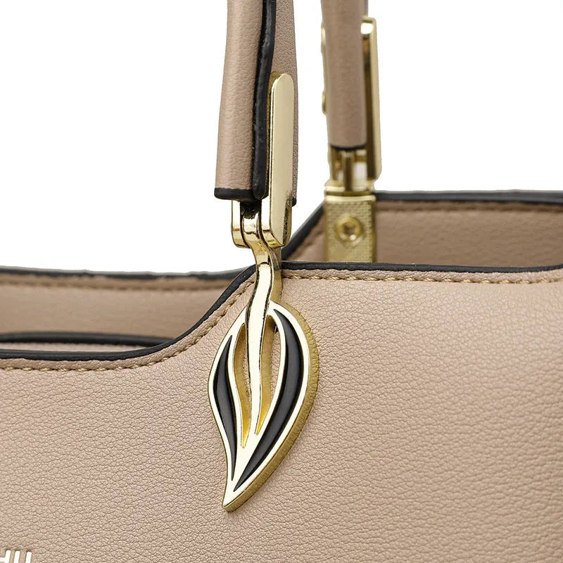 Women's black PU messenger bag with multi-layer design and visible sewing thread detail.