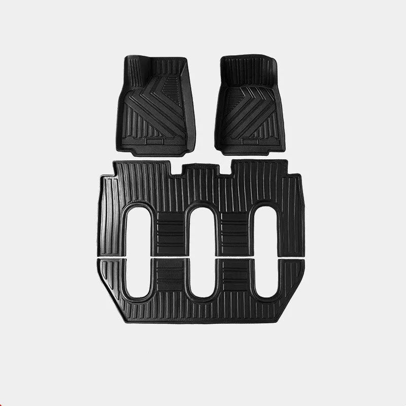 Tesla Model X black TPE rubber floor mats and boot liner set on car interior.