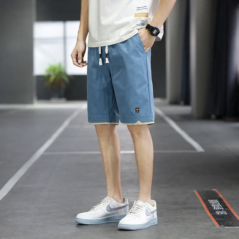 Men's loose fit straight leg beach shorts in various colours with elastic waistband