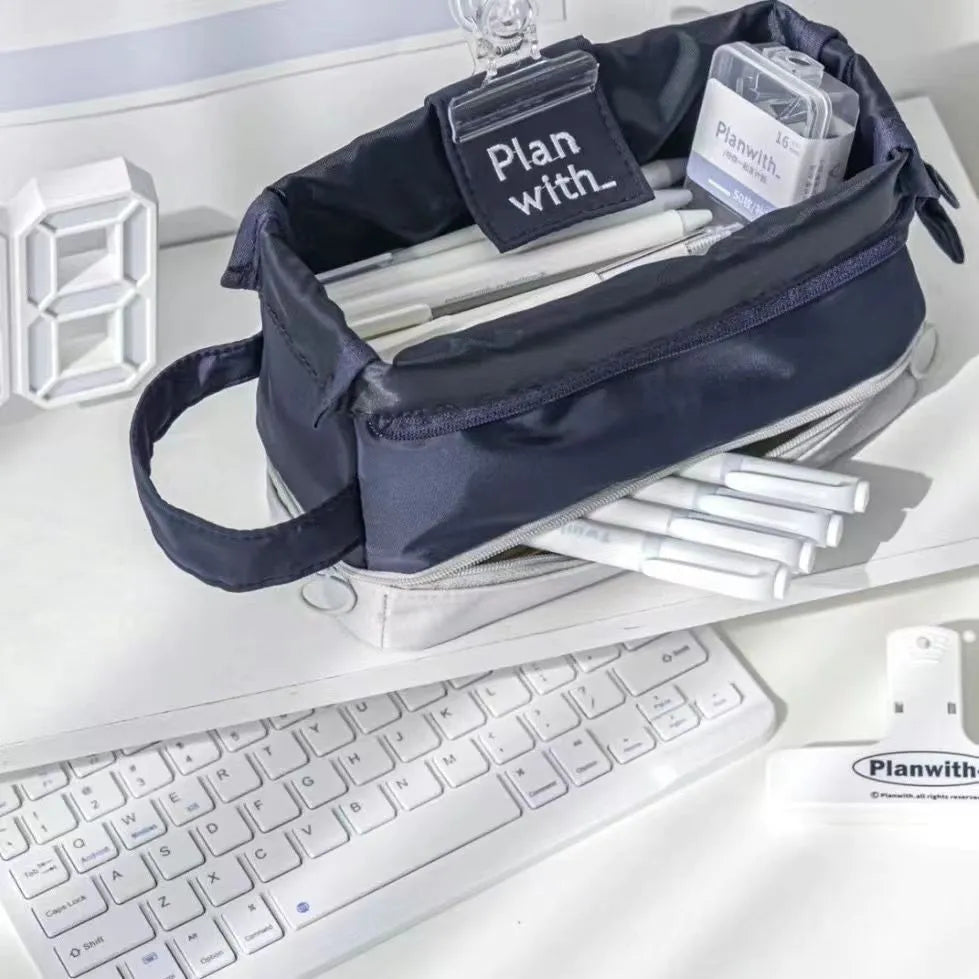 Folding double-layer polyester pencil case in dark blue, blue, and cream white colours with organised compartments