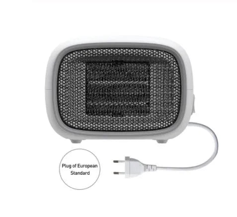 Compact green portable ceramic fan heater with metal grille, shown on a desk