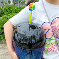Yellow silicone sunflower decoration with suction cup for attaching to a helmet.
