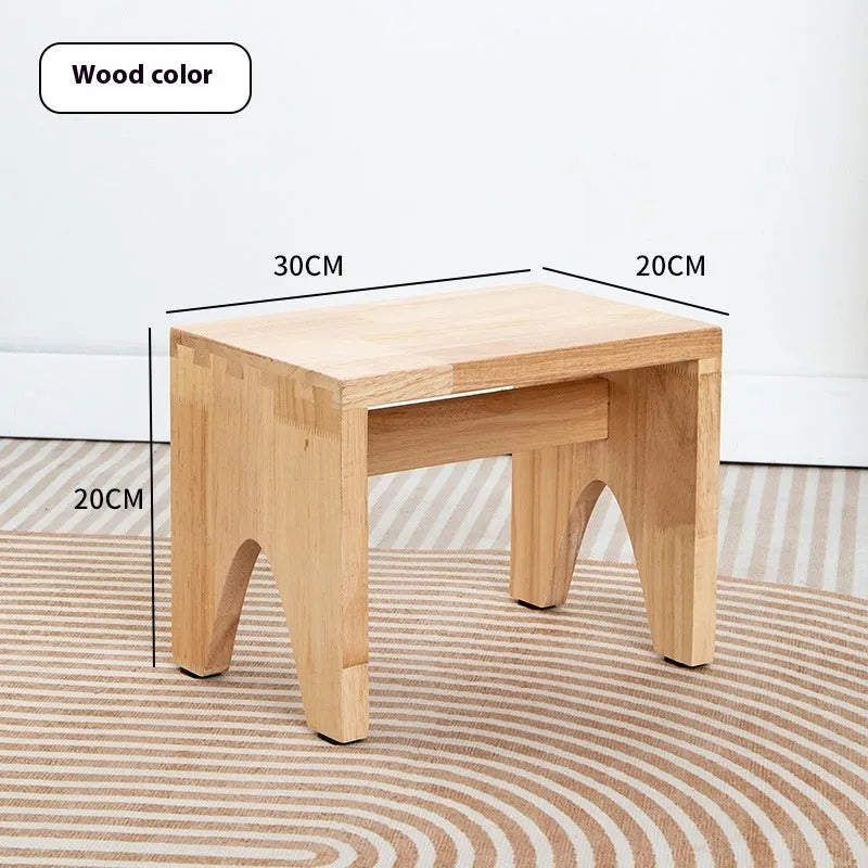 Solid wood shoes changing stool with distressed finish and bracket leg structure.