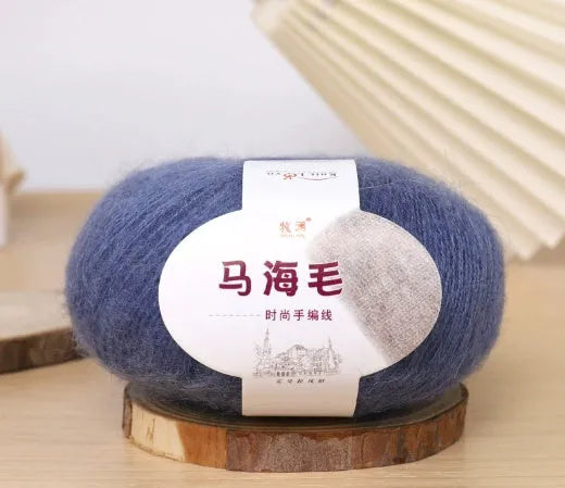 DIY mohair scarf weaving kit showing one wool ball and a selection of 34 colour options including white, pink, blue and green.