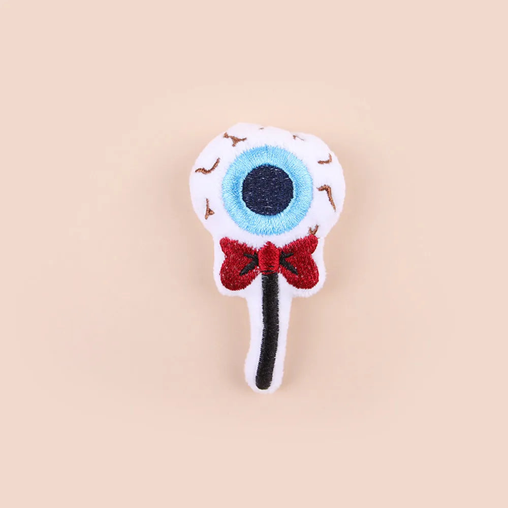 Colourful plush cat tease stick with candy, eyes and skull designs on small wand toy