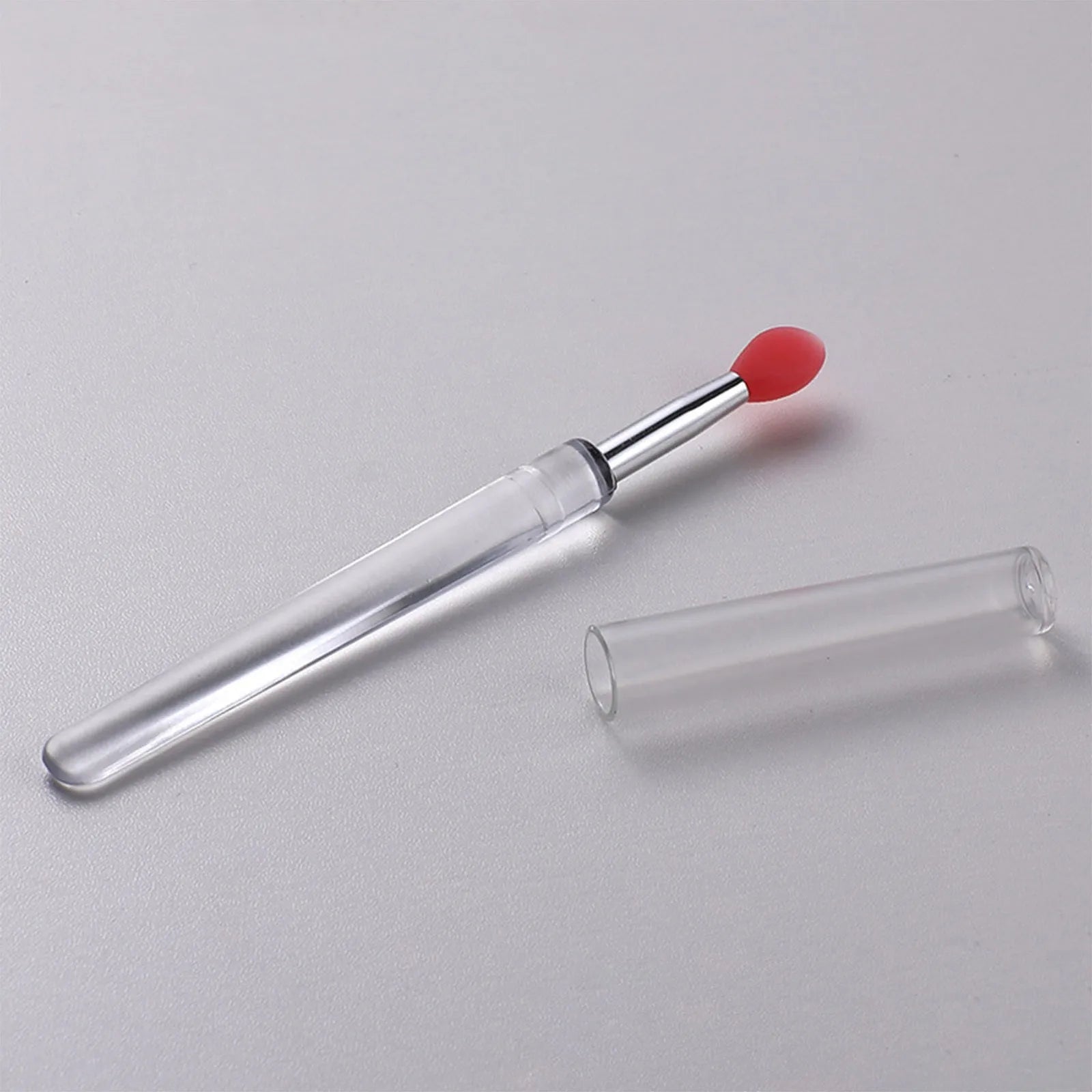 Set of silicone lip brushes with caps in various colours including blue, pink, and purple.