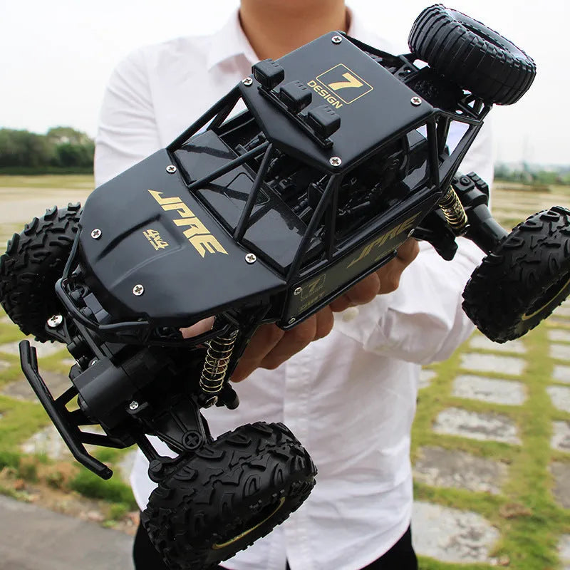 Large 4WD remote control climbing car with 2.4G wireless remote on off-road terrain