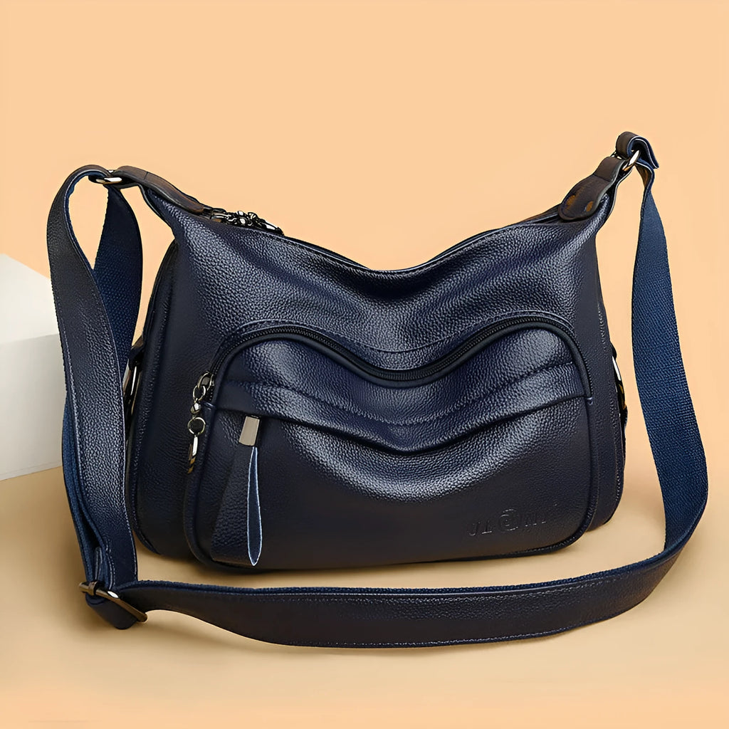 Blue women's large crossbody shoulder bag with multiple internal compartments and soft horizontal square design