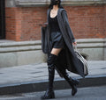 Long grey knitted women's cardigan trench coat with a hood and long sleeves.