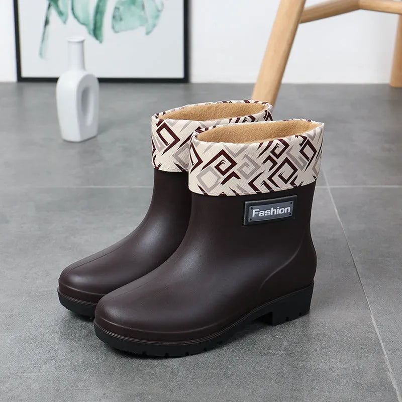 Women's black PVC rain boots with mid-calf height and low heel
