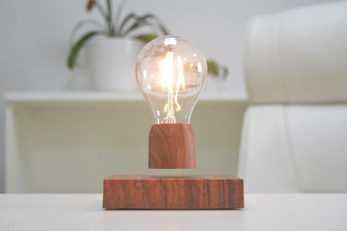 Magnetic levitation floating light bulb hovering above imitation wood base with universal voltage specification