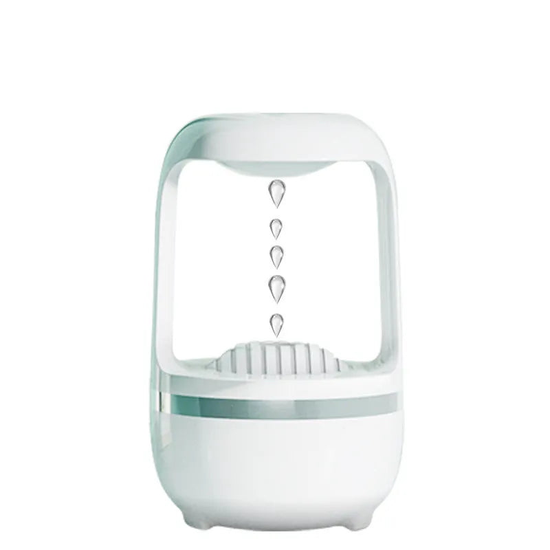White anti-gravity water droplet humidifier with aromatherapy function on a desk.