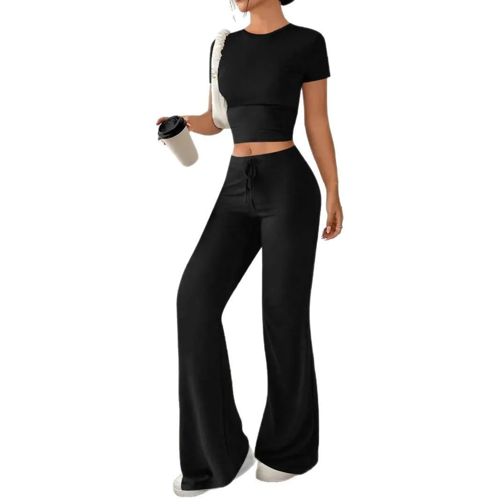 Black women's co-ord set with high waist trousers and regular sleeve T-shirt laid flat
