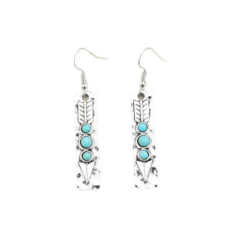 Silver geometric drop earrings with turquoise inlay details on white background