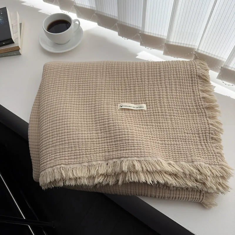 Four-layer gauze cotton blanket with knotted tassels in avocado green colour