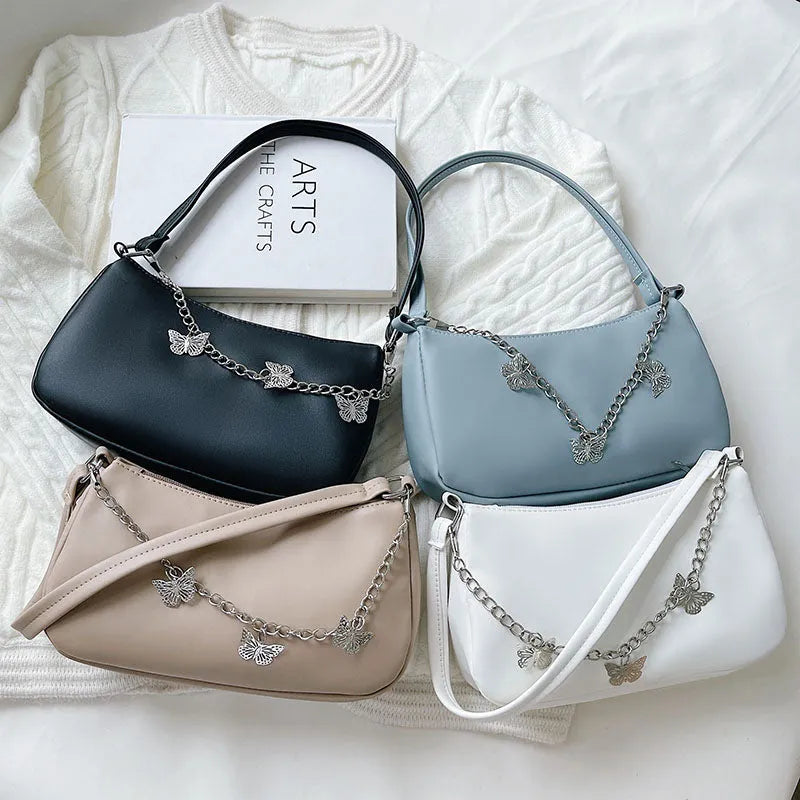 Butterfly chain crossbody bag in PU leather with a retro style, shown in light blue.