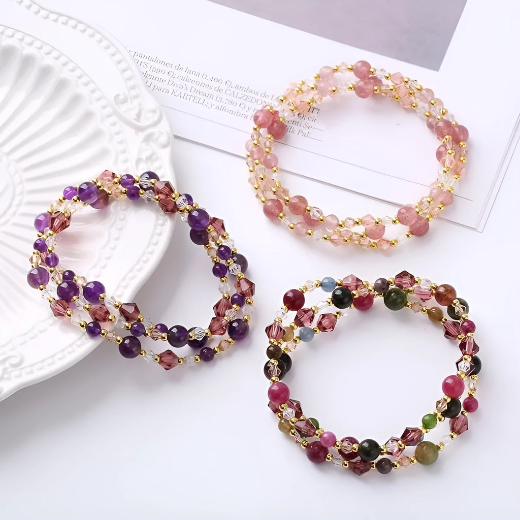 Women's adjustable three-ring crystal bracelet with tourmaline, strawberry quartz, and amethyst beads.