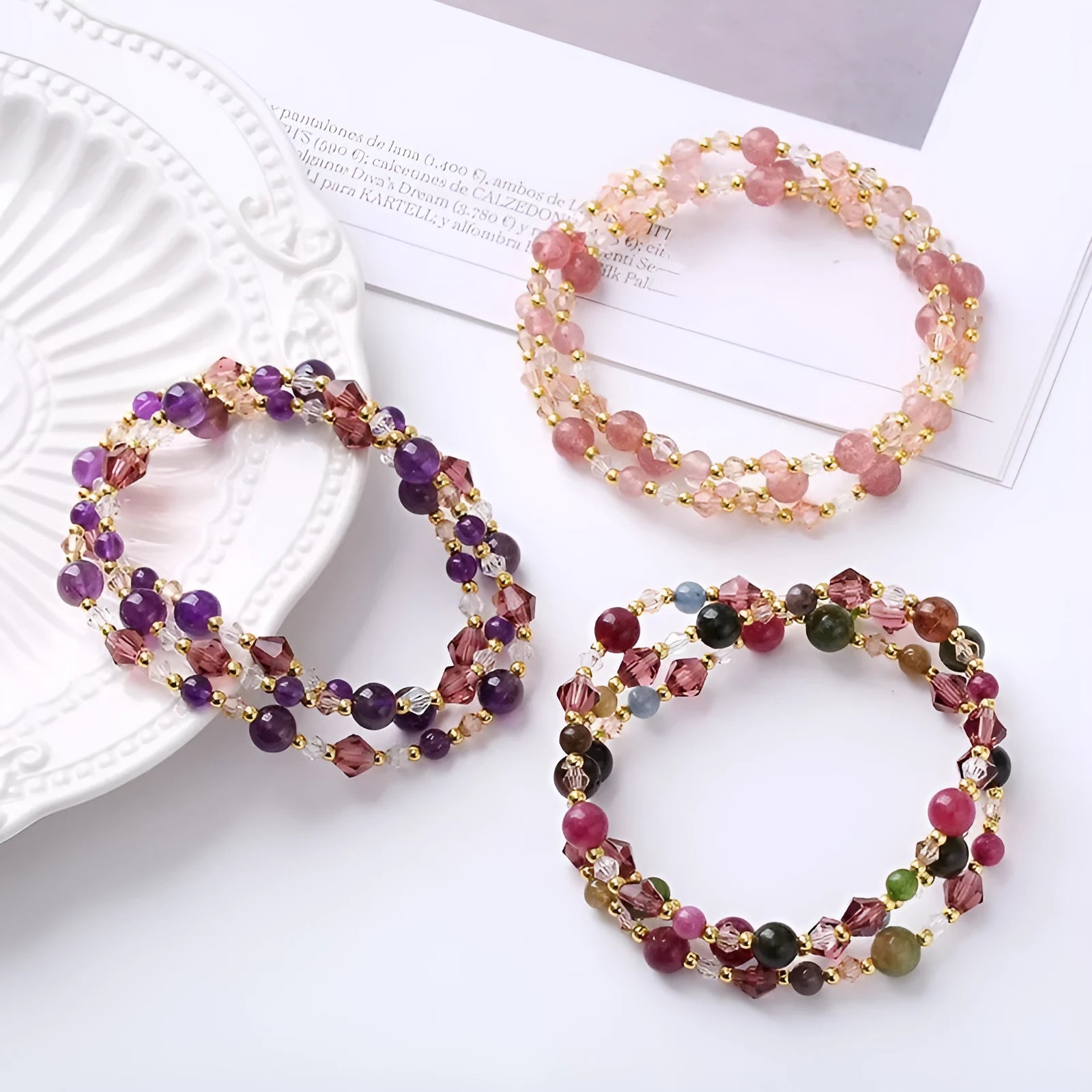 Women's adjustable three-ring crystal bracelet with tourmaline, strawberry quartz, and amethyst beads.