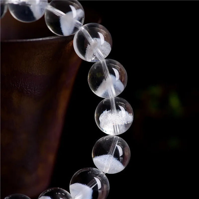 Women's natural white crystal pyramid ghost bracelet with Ruyi charm showing bead texture