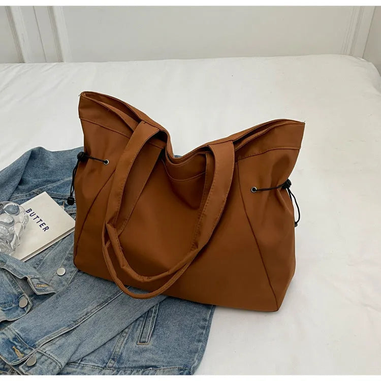 Soft Oxford cloth foldable commuter tote bag in street style, shown in multiple colour options.