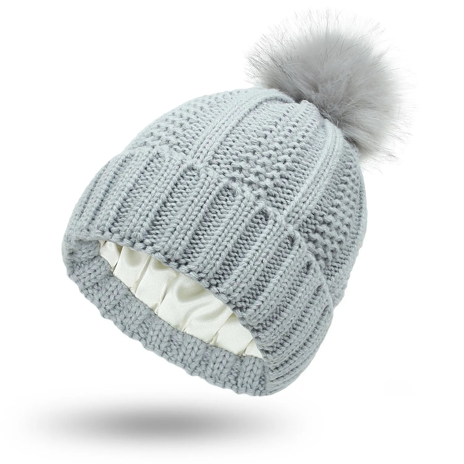 Wool knitted beanie hat with satin lining and faux fur pom pom in beige colour