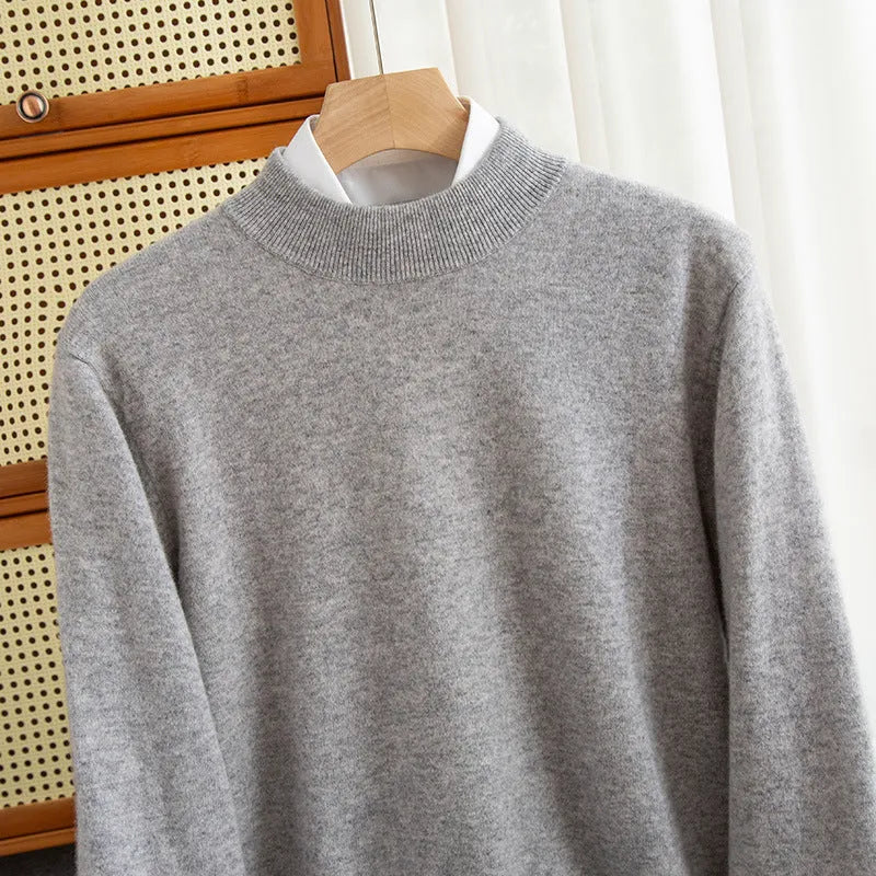Men's loose fit half-turtleneck wool sweater in a neutral colour on a hanger.