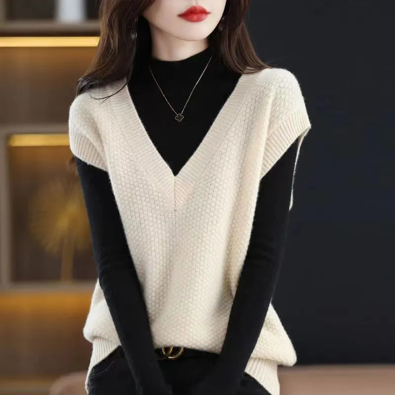 Cashmere acrylic knitted sleeveless V-neck vest with a raised 3D pattern, shown in creamy-white colour.
