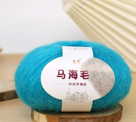 DIY mohair scarf weaving kit showing one wool ball and a selection of 34 colour options including white, pink, blue and green.