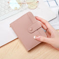 Women's short PU leather wallet with lychee pattern in beige, pink, black, or red.