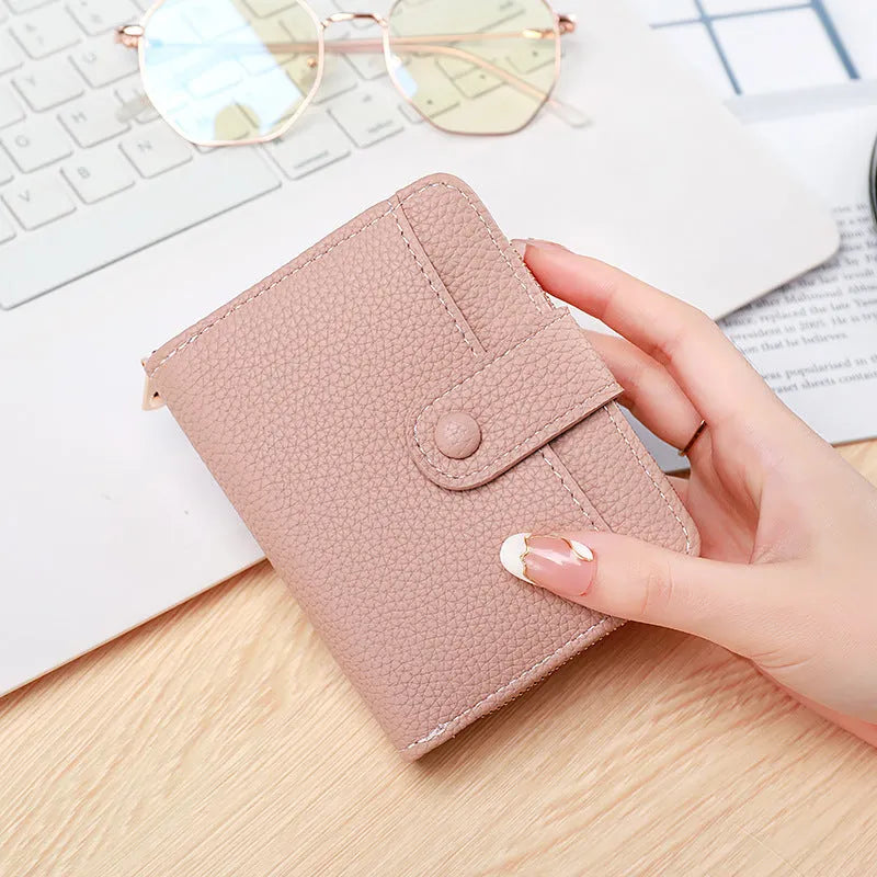 Women's short PU leather wallet with lychee pattern in beige, pink, black, or red.
