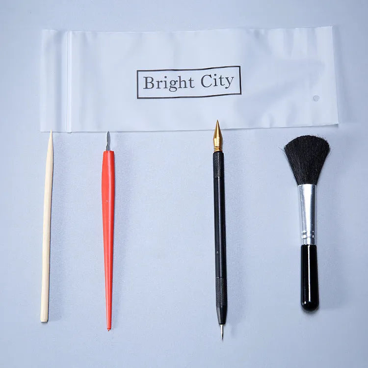Scraping painting tools kit with white card paper, scraping pens, brushes, and art accessories for scratch artwork