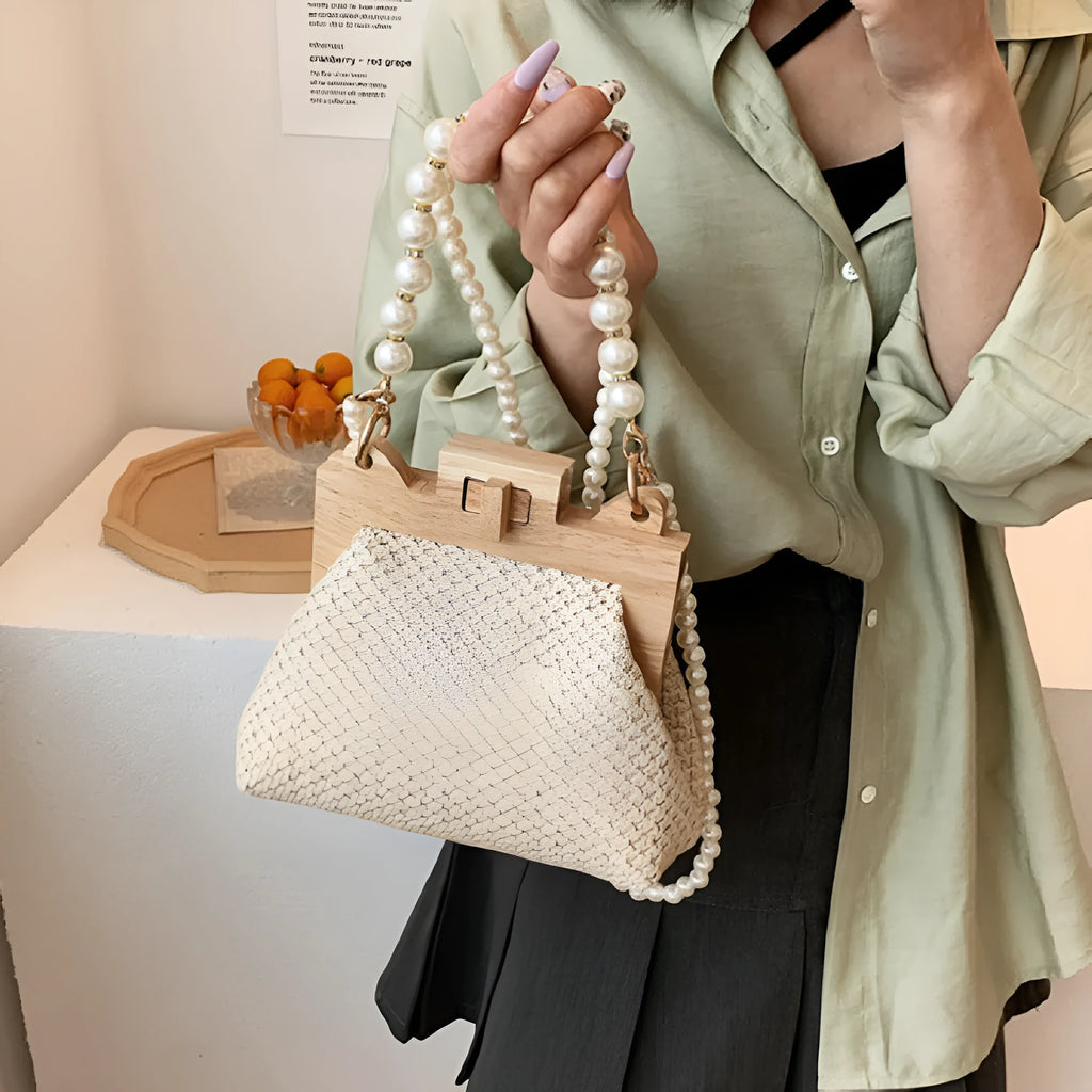 Women's straw shoulder bag with pearl chain strap in beige colour showing organised interior with compartments