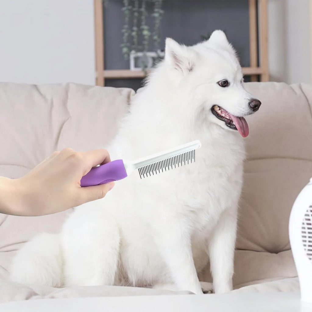 Purple pet detangling comb with stainless steel teeth and ergonomic handle.