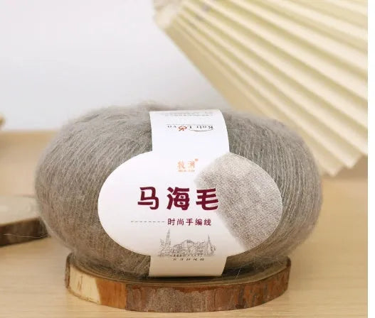 DIY mohair scarf weaving kit showing one wool ball and a selection of 34 colour options including white, pink, blue and green.