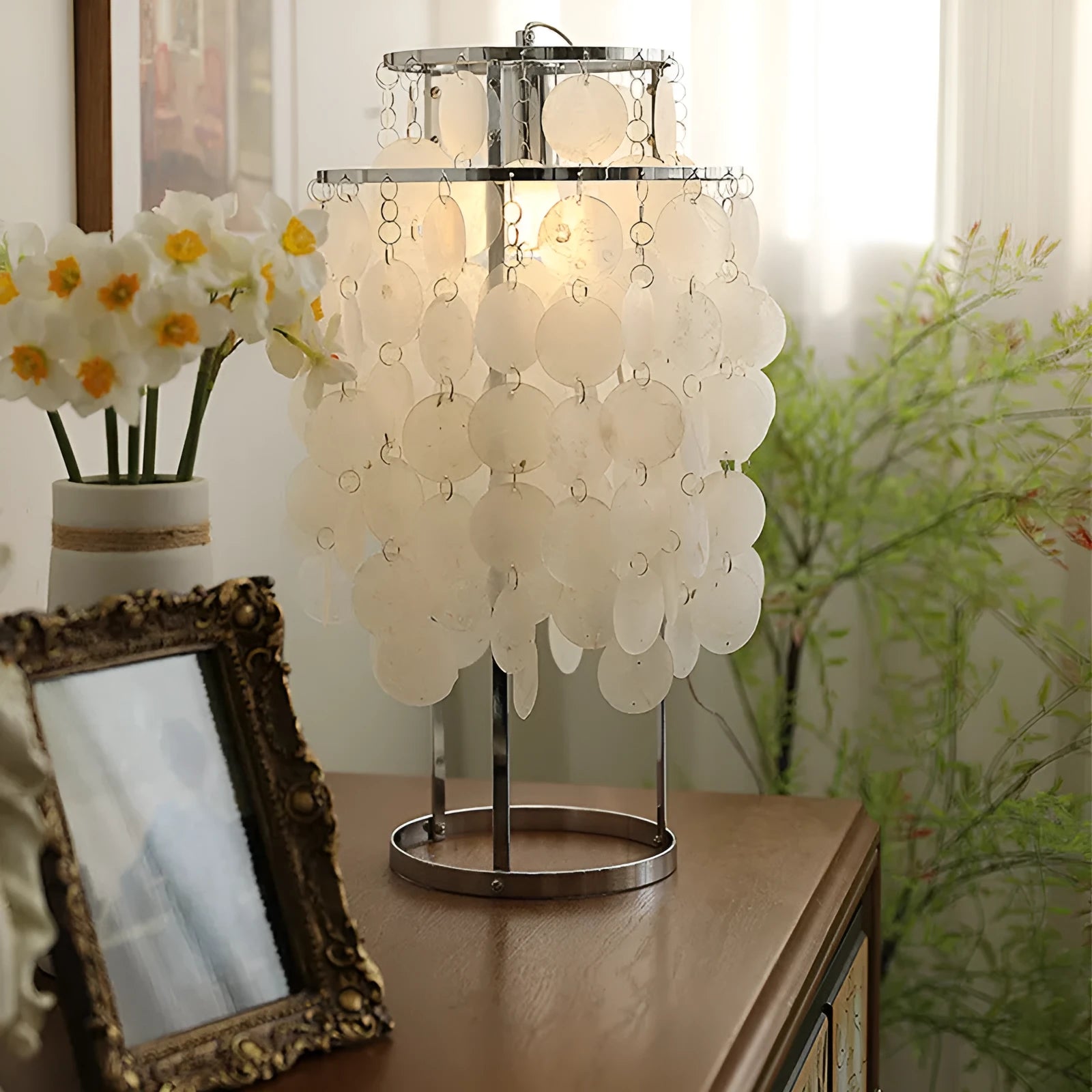 Modern shell bedside table lamp in chrome finish with 30cm diameter shade