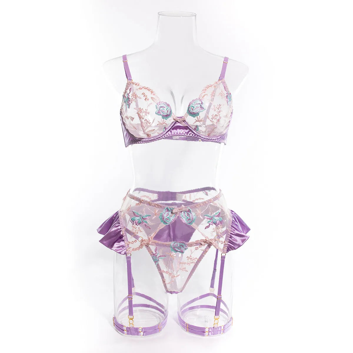 Light purple satin lingerie four-piece set with white embroidery detailing on a mannequin