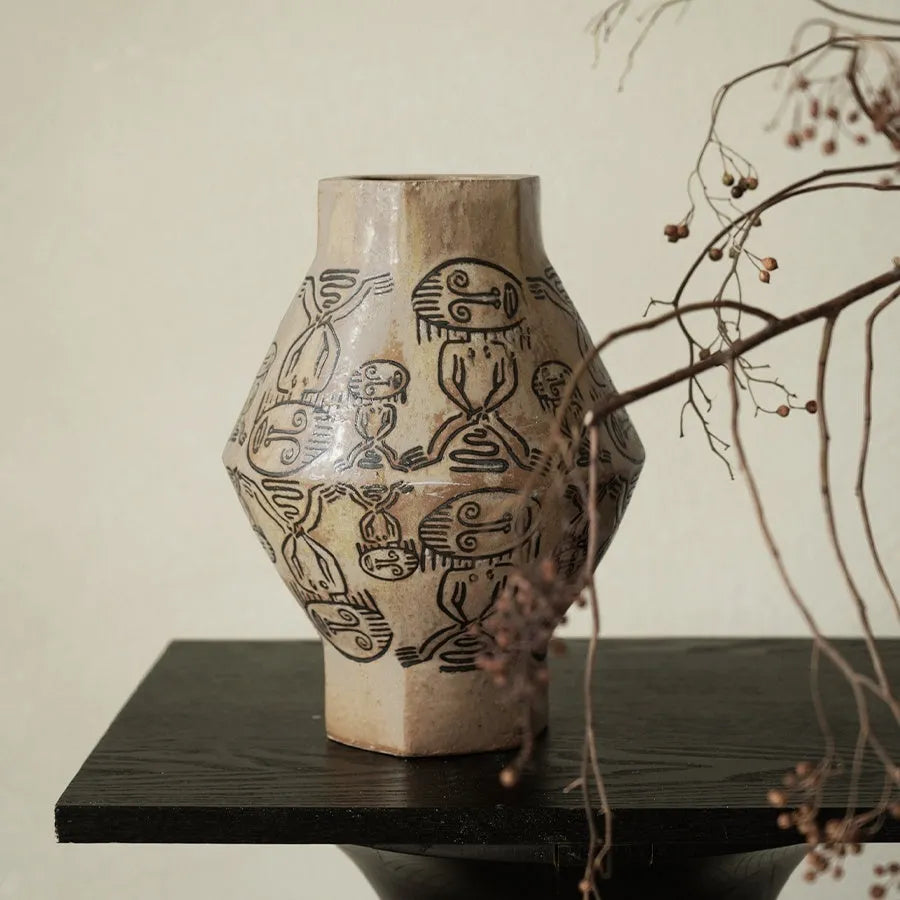 Hand-painted ceramic vase with carved tribal totem flower pattern in cylindrical shape