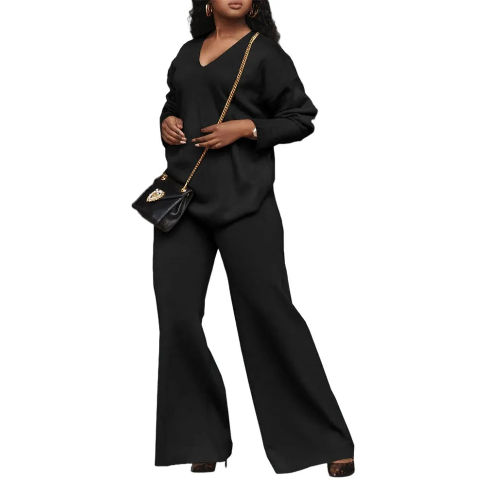 Women's brown suede two-piece suit with split sleeve detail on the long-sleeved top and matching trousers.