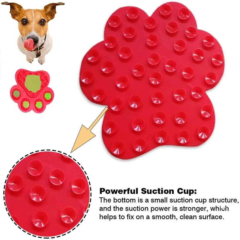 Blue silicone dog licking mat with bone texture and suction cups on the back, placed on a tiled wall.