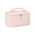 Open-top pink PU leather cake-style makeup bag on a table
