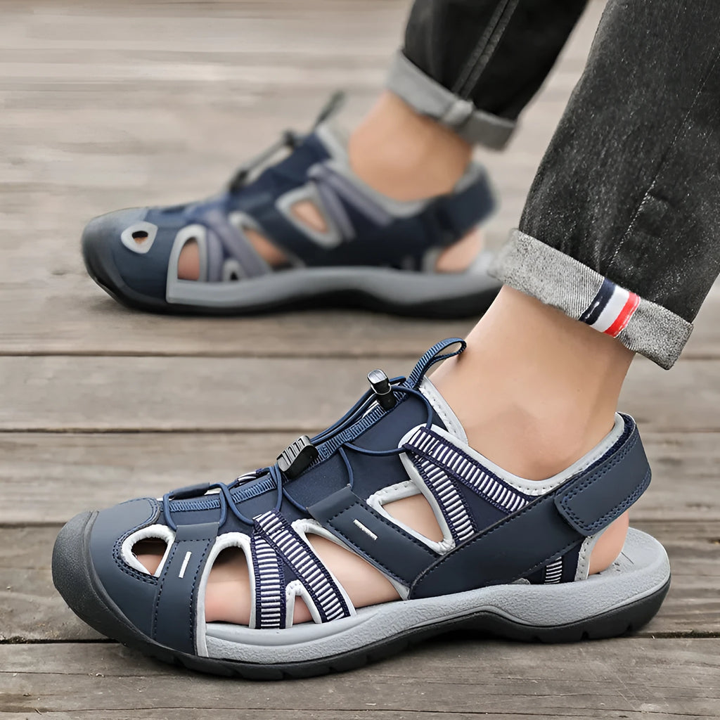 Men's blue casual sports shoe with Velcro straps, mesh upper, and rubber sole.