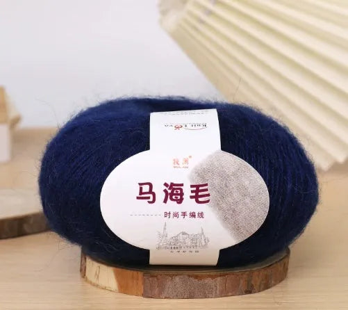 DIY mohair scarf weaving kit showing one wool ball and a selection of 34 colour options including white, pink, blue and green.