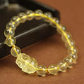 Yellow leather cord bracelet with an artificial citrine crystal Pi Xiu charm and beads.